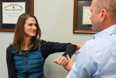 Doctor and a woman standing next to each other